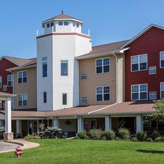 A well-maintained residential building with a tower, likely serving as a senior living or retirement home.
