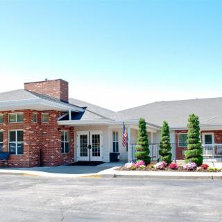A modern brick building with well-maintained landscaping and a welcoming entrance.