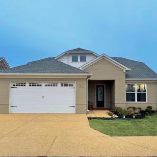 A suburban house with a two-car garage and well-maintained lawn.