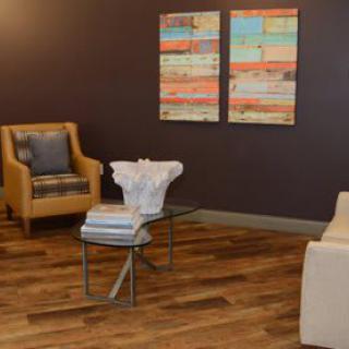 A modern living room with stylish furniture and abstract artwork.