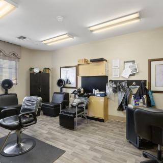 A well-equipped hair salon with chairs and styling stations.