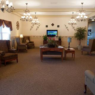 Spacious living area with comfortable seating and elegant chandeliers.
