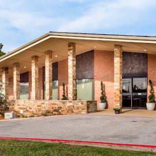 A modern building featuring brick architecture with distinct columns and a welcoming entrance.