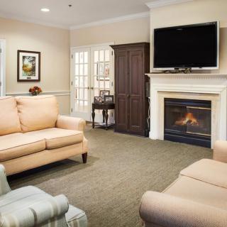 A cozy living room featuring a fireplace and comfortable seating.
