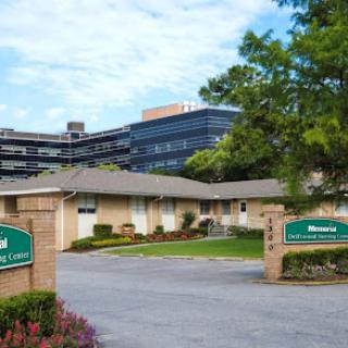 A view of a healthcare facility with a modern building in the background.