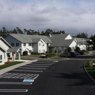 A suburban residential area with houses and a parking lot.