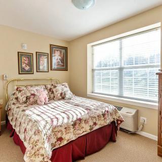 A cozy bedroom with floral decor and natural light.