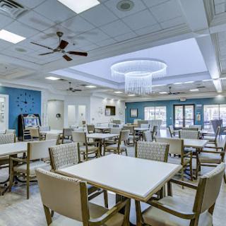 A spacious and modern dining area with contemporary furnishings and ample natural light.