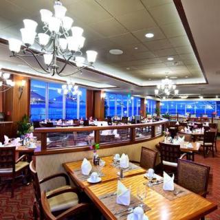 A beautifully designed restaurant interior featuring elegant chandeliers and neatly arranged tables.