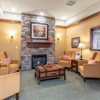 A cozy living room with a fireplace and comfortable seating.