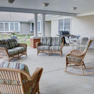 A cozy patio with wicker furniture and a covered outdoor space.