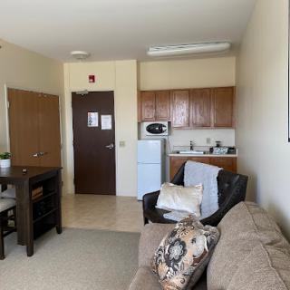 A cozy apartment featuring a living room with a kitchenette.