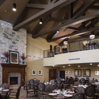 Spacious dining area with elegant decor and a cozy fireplace.
