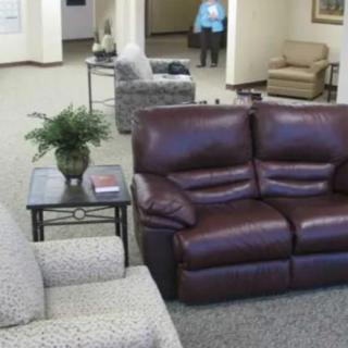 A cozy waiting area with comfortable seating and a coffee table.