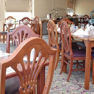 A cozy restaurant dining area with wooden chairs and tables.