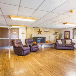 A cozy living room with comfortable seating and a fireplace.