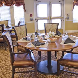 A neatly arranged dining room table set with plates and napkins.