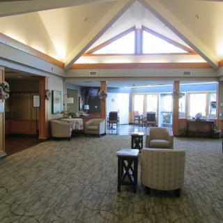 A spacious lobby area with comfortable seating and large windows.