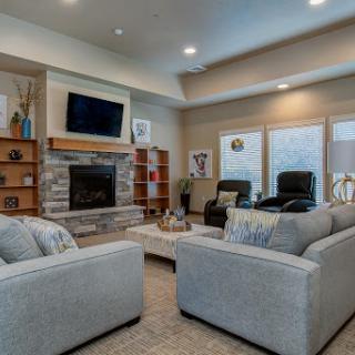 A cozy and modern living room featuring a fireplace and ample seating.