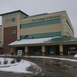 A college building partially covered in snow during winter.