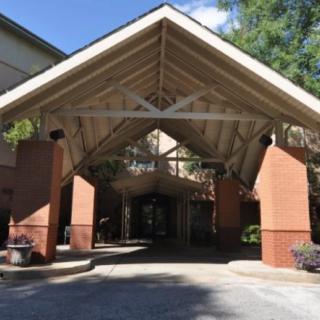 A covered entrance with brick pillars and a triangular roof structure.