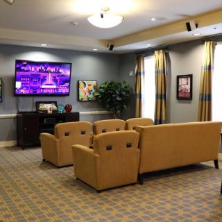 Cozy living room with comfortable seating and a large television.