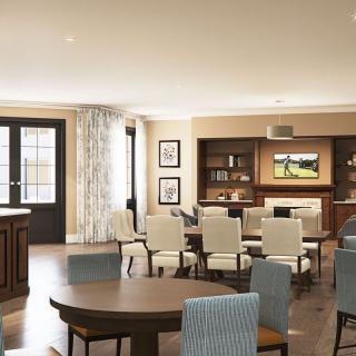 A spacious and modern dining room with elegant furniture and a television mounted on the wall.