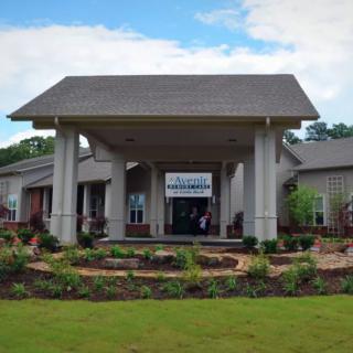 A modern building entrance with landscaped surroundings.