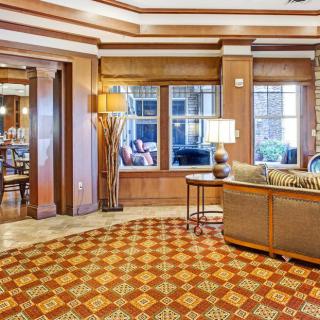 A well-decorated hotel lobby featuring comfortable seating and large windows.