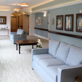 A well-decorated lobby area with sofas and artwork on the wall.