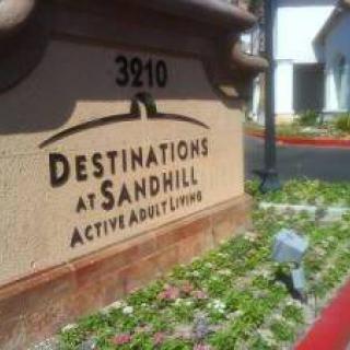Entrance sign for Destinations at Sandhill, an active adult living community.