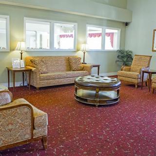 A cozy living room with classic furniture and a warm carpet.