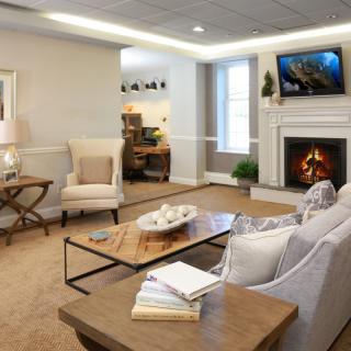 A cozy living room with a fireplace and comfortable seating arrangement.