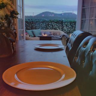 A cozy dining setup with a scenic mountain view through the window.
