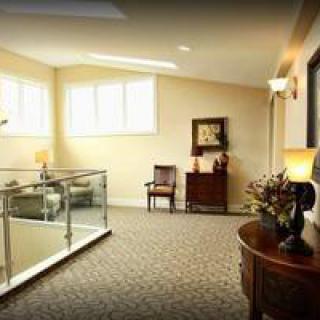 A well-lit hallway with elegant furniture and decor.