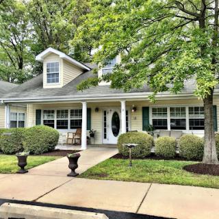 A charming house with a well-maintained front yard and welcoming porch.
