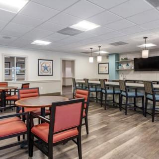 A modern dining area with tables and a bar counter.