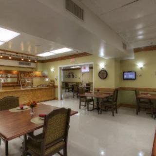A cozy restaurant interior with a dining and bar area.