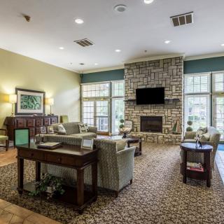 A cozy living room with a fireplace and comfortable seating.