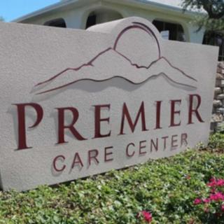 Sign for Premier Care Center in front of a building.