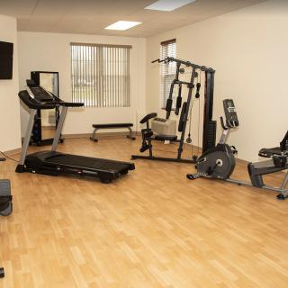 A well-equipped gym with various exercise machines.