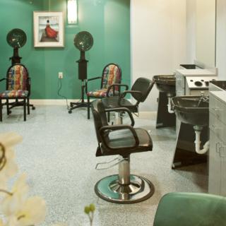 An empty hair salon with styling chairs and equipment.