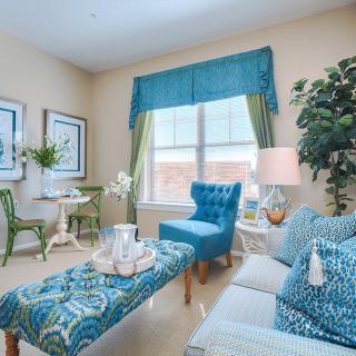 A bright and cozy living room with blue decor and comfortable seating.