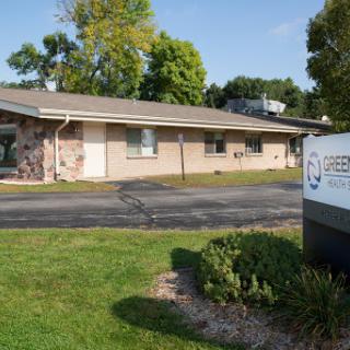A well-maintained office building surrounded by green landscaping.