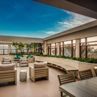 A modern rooftop lounge with comfortable seating and scenic views.