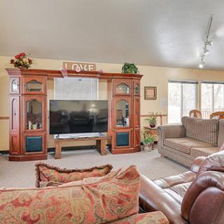 A cozy living room featuring elegant wooden furniture and ample natural light, perfect for relaxation.