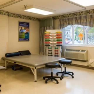 A physical therapy room equipped with treatment tables and therapy tools.