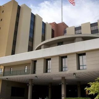 A hospital building with an American flag on top.