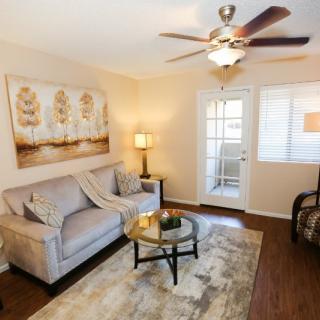 A cozy living room with a sofa, coffee table, and warm lighting.