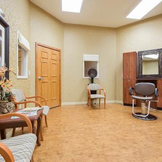 A well-organized salon interior with chairs, mirrors, and a hair dryer.